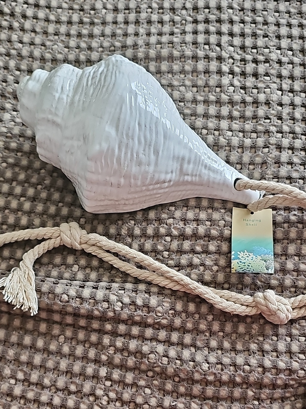 Cracker Barrel Cream Rope Knot Accent with Beige Textured Background